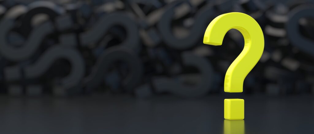 Bright yellow question mark standing out against a dark background, symbolizing inquiry and uncertainty.