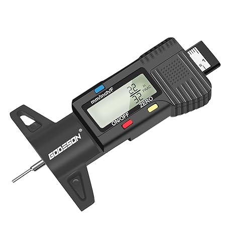 A black tread depth gauge with a needle in the front which is used to measure the tread depth, a ruler in the back, and a digital display reading 22/32 in FRAC. There are two buttons: one red button that reads ON/OFF, and a yellow one that reads ZERO. In the front, next to the needle, there is the name of GODESON, which is the brand of the tread gauge. 