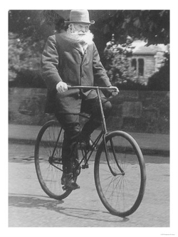 Historical photograph of a man, John Boyd Dunlop, riding a bicycle from the early 1900s, representing the pioneering era of tire development and innovation, including the invention of pneumatic tires, key to answering 'what is the tire made of'.