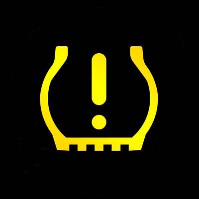 Yellow tire pressure warning light symbol showing an exclamation point inside a U-shaped icon with a flat bottom, displayed on a black background. This dashboard warning light indicates low tire pressure or TPMS system malfunction.