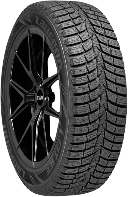 The Laufenn I FIT Ice LW7 winter tire, mounted on a black, luxury looking rim. The Laufenn's text can be read on the tire's sidewall. The tire's deep grooves and intricate sipes can also be seen in detail in the picture.