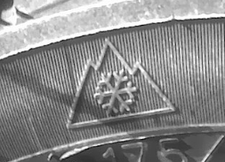 The Three-Peak Mountain Snowflake symbol on a tire's sidewall. Under it, a part of a number "175" can be seen. 