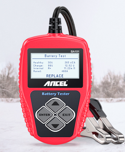 A red Ancel Car Battery Tester device with its both black and red cables next to it. The background is a winter landscape with snow and some trees without leaves. On the screen of the device there is information about the tested battery with a big text reading "Replace".